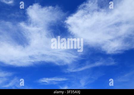 Cloudscape. Concepts - environment. Cirrus and cirrostratus clouds with a deep blue sky. Backgrounds. Copy space. Stock Photo