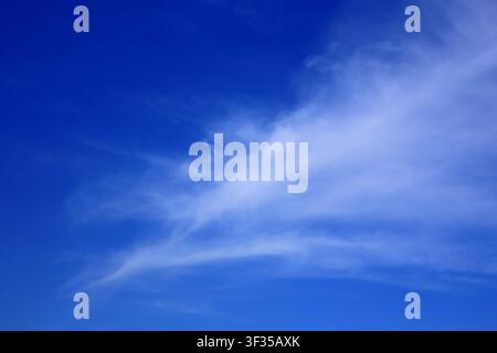 Cloudscape. Concepts - environment. Cirrus and cirrostratus clouds with a deep blue sky. Backgrounds. Copy space. Stock Photo