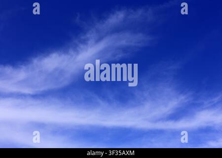 Cloudscape. Concepts - environment. Cirrus and cirrostratus clouds with a deep blue sky. Backgrounds. Copy space. Stock Photo