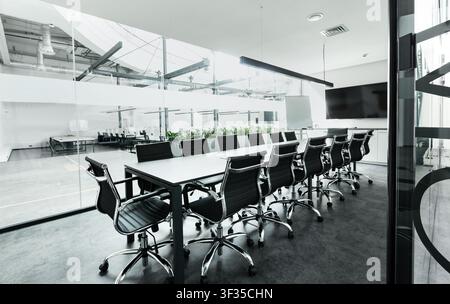 Table with chairs in conference room, modern loft office Stock Photo