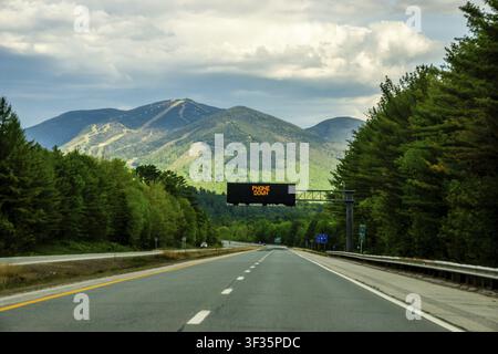 Highway Leading Toward Cannon Mountain Through Forested New Hampshire Landscape Stock Photo