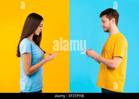 Portrait of young couple using their cellphones Stock Photo