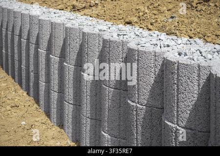 Boundary wall made of hollow concrete blocks Stock Photo