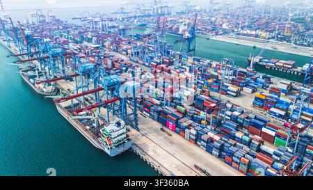 Aerial view of a busy shipyard with numerous cargo ships and boats ...