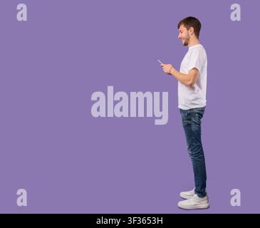 Portrait of handsome young man using mobile phone Stock Photo