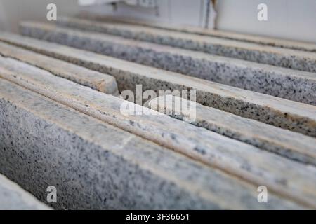 Close-up of stacked grey granite slabs in a warehouse for construction and interior design projects Stock Photo