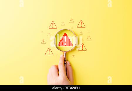 Risk detection and warning alert concept. magnifying glass to zoom in on red exclamation, hazard search, issue identification, safety inspection, Stock Photo