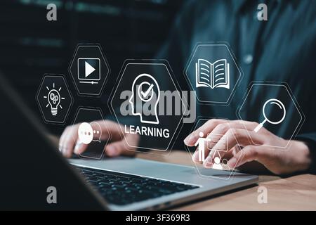 Digital learning platform and online education concept. Student using laptop with learning icon, video lesson, ebook, search tool, training, knowledge Stock Photo