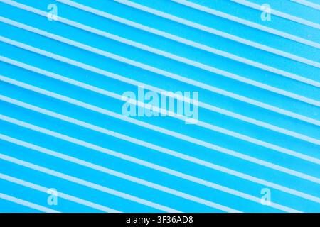 Diagonal white stripes pattern on bright blue background, abstract geometric textured surface Stock Photo