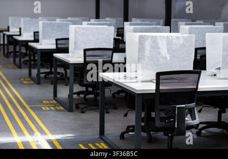 Office interior many covered computers and workplaces with no people Stock Photo