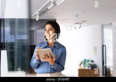 Businesswoman using digital tablet at modern office Stock Photo