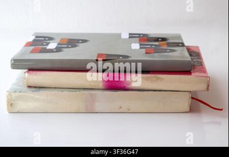 Close-up shot of a stack of antique story books on clean surface. Old books stacked up for academic research, library learning, and historical novel c Stock Photo