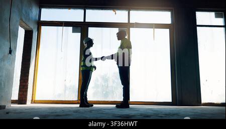 People, handshake or engineers on construction site for agreement, development deal or welcome. Contractor, team or shaking hands with collaboration Stock Photo