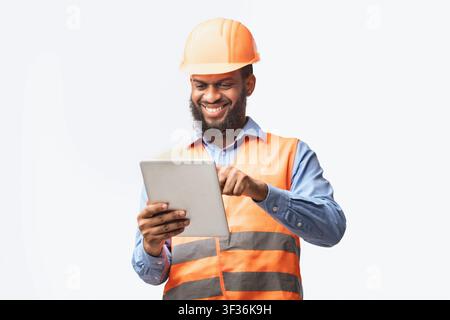 Architect Using Digital Tablet Working On Construction Site, White Background Stock Photo