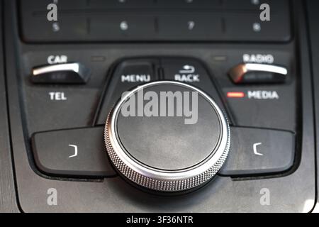 Detailed shot of interior vehicle console, highlighting premium design of infotainment interface. Focus on ergonomic control elements, including promi Stock Photo