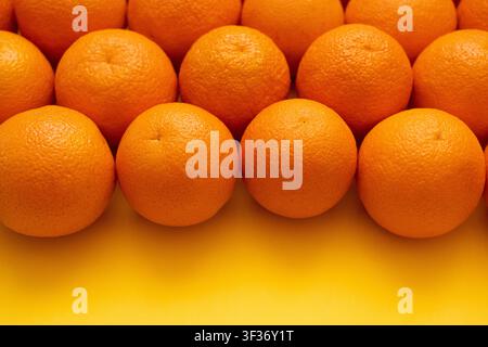 Many whole oranges pile. Clementine fruits background, fresh citrus big group on market, mandarin heap in supermarket Stock Photo