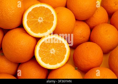Many whole oranges pile. Clementine fruits background, fresh citrus big group on market, mandarin heap in supermarket Stock Photo