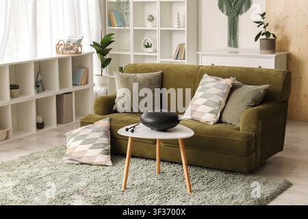 Interior of living room with green sofa and glucophone on table Stock Photo