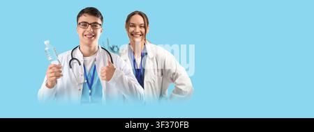Smiling young male doctor holding a water bottle and giving a thumbs up next to a female doctor making an okay gesture, Healthcare professionals promo Stock Photo
