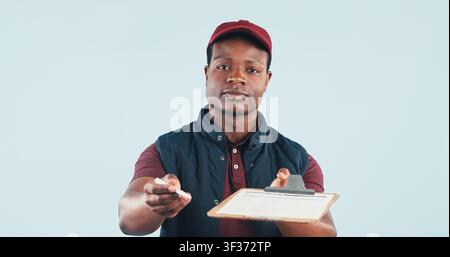 Portrait, clipboard and courier man in studio for signature, postal service or distribution with space. Black person, delivery or shipping for order Stock Photo
