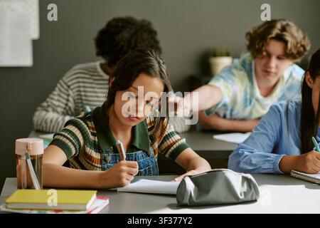 Diverse Teen Students Preparing Notes in Classroom for School Success Stock Photo