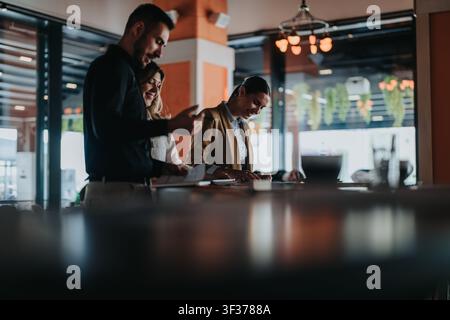 Colleagues collaborating on a business project during a casual remote work meeting in a modern office Stock Photo