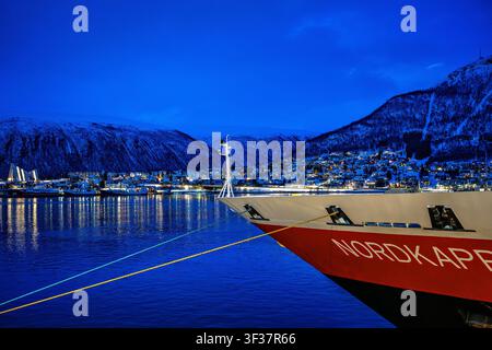 Tromso, Norway, 27.04.2026: Hurtigruten's MS Nordkapp anchors in Tromso, Norway, at midnight, copy space Stock Photo