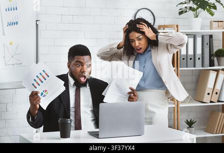 Stressed African American colleagues missing project deadline at office Stock Photo