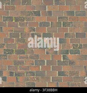 High angle view of weathered red and dark grey rectangular brick pavers forming a textured floor pattern. Stock Photo