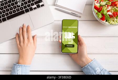 Woman tracking an order using cell phone Stock Photo