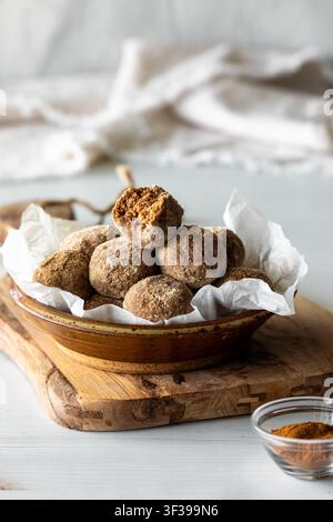 Cinnamon and protein powder dusted energy balls in a bowl. Stock Photo