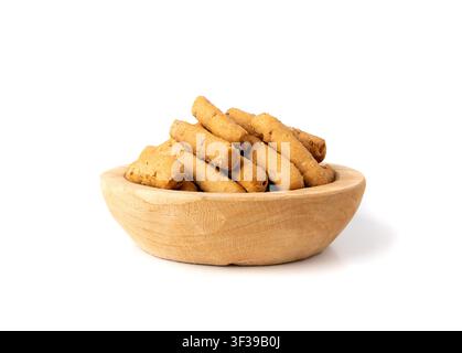 Small breadsticks, short grissini or picos with fragrant herbs and seeds in wood bowl isolated. Crispy mini bread sticks on white background Stock Photo