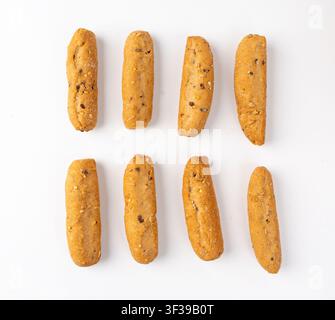 Small breadsticks, short grissini or picos with fragrant herbs and seeds isolated. Crispy mini bread sticks on white background Stock Photo