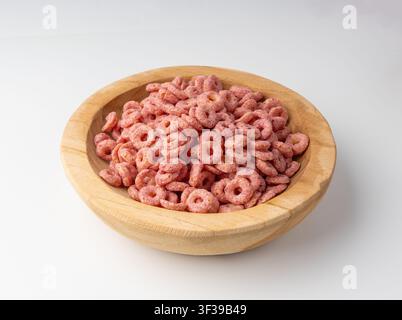 Pink Cereal Rings Isolated, Fruit Breakfast Rice Loops in Bowl, Corn Cereals Snack on White Background Stock Photo