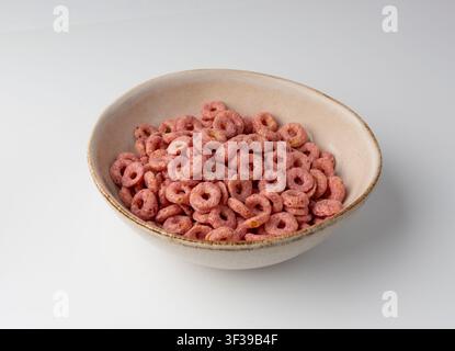 Pink Cereal Rings Isolated, Fruit Breakfast Rice Loops in Bowl, Corn Cereals Snack on White Background Stock Photo