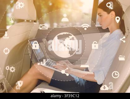 Business woman using laptop in backseat of luxury car Stock Photo