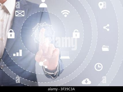Business man in suit pressing button on infographic panel Stock Photo