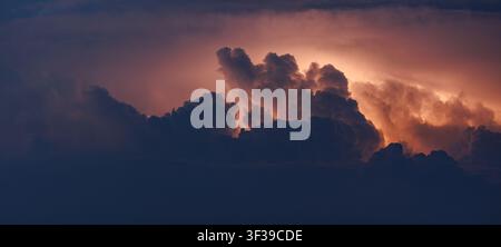 Lightning bolts in the cumulus clouds, powerful storm Stock Photo
