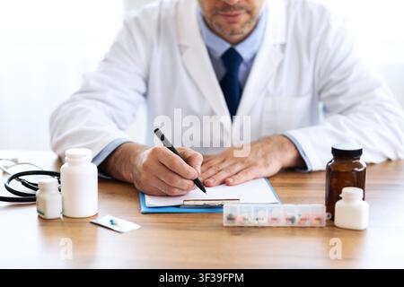Close up of medical practitioner writing prescription Stock Photo