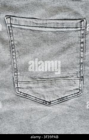 Close up view back pocket on washed grey denim jeans with detailed stitching and texture Stock Photo