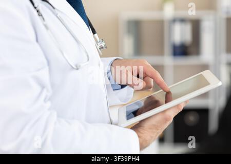Side view of medical practitioner using digital tablet Stock Photo