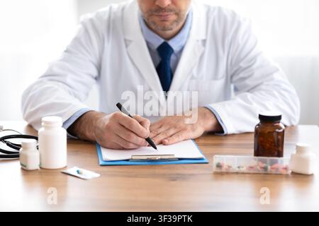 Close up of medical practitioner filling in paperwork Stock Photo