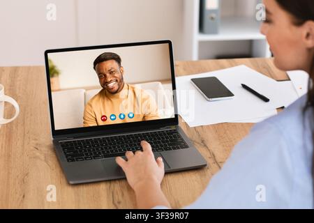 Woman having discussion during video call with colleague Stock Photo