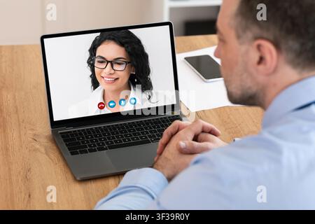 Workers having online discussion during video call at home Stock Photo