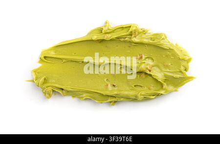 Pistachio cream isolated, dubai green chocolate butter, green nut paste. Creamy sweet smear, matcha icecream, pistachio mousse or sauce on white backg Stock Photo