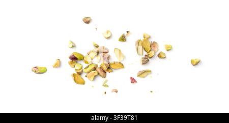 Fried salt pistachio nuts pieces pile isolated. Baked broken pistachios grains, crumbled roasted green pistache fruits and chopped kernels on white ba Stock Photo