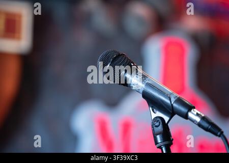 Dynamic microphone on a dark stage setup, ready for a concert or public speaking event Stock Photo