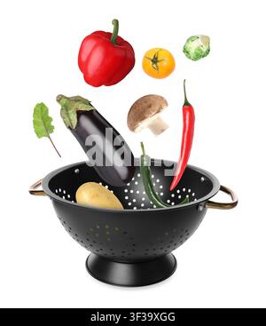Fresh vegetables falling into colander on white background Stock Photo