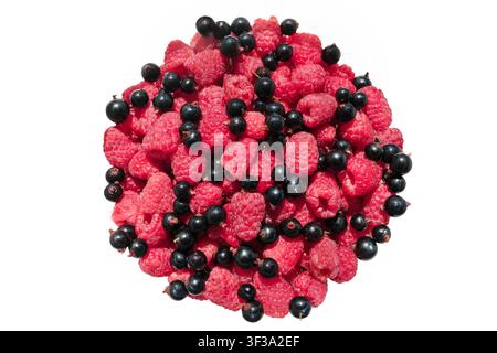 Top view of fresh raspberries and black currants isolated on white background. Heap of summer red and black berries. Stock Photo