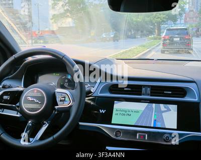 DALLAS, TX, USA - JULY 13, 2026: The interior of a Waymo Jaguar vehicle is shown navigating a street in Dallas. Waymo is known for its autonomous driv Stock Photo